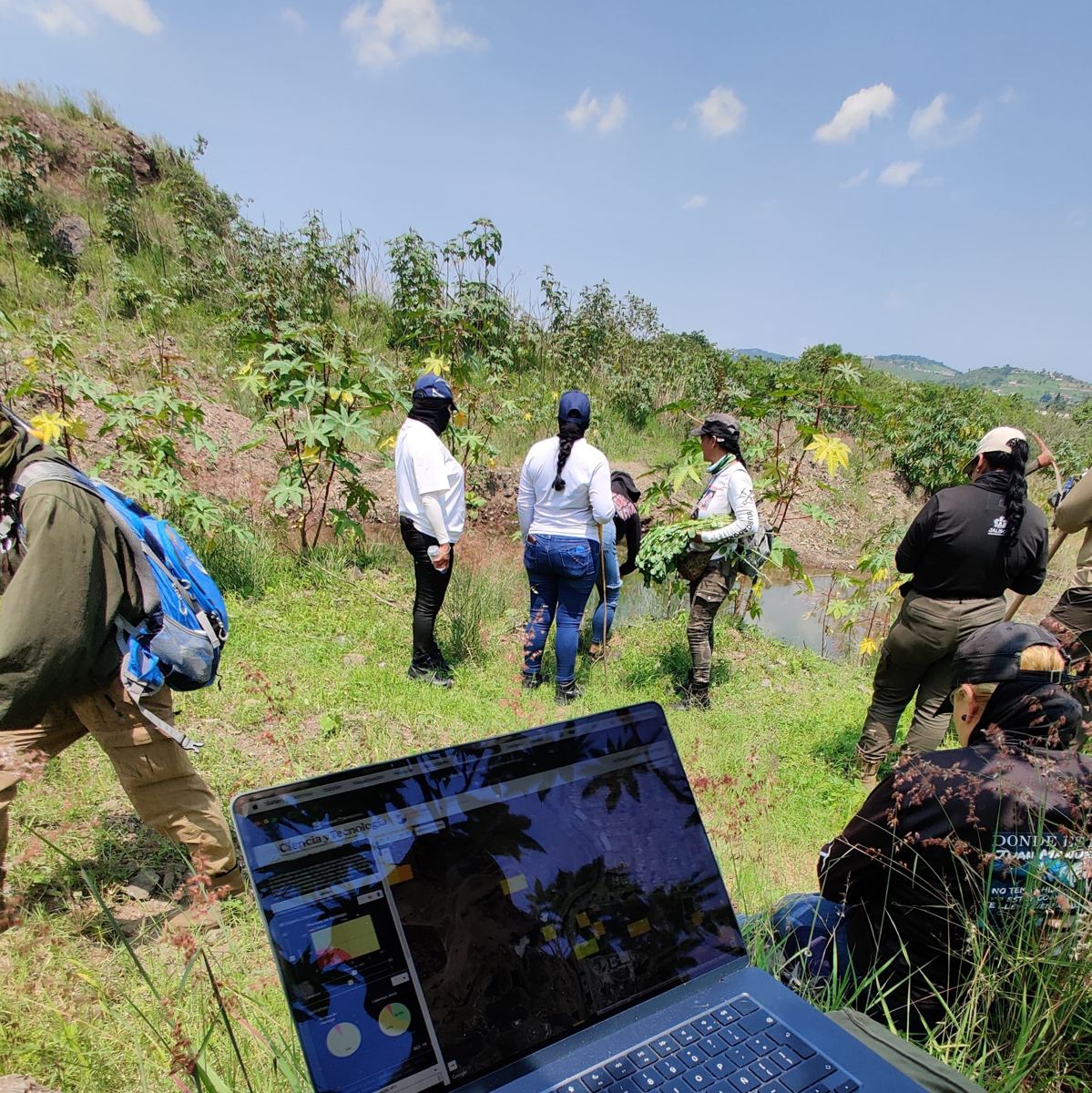 Searching families and officials at a field site, with the search platform open on a laptop in the foreground